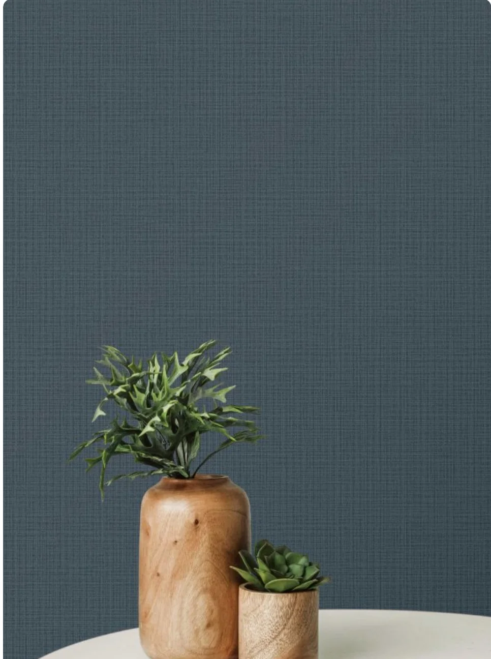Minimalist space with dark surface against a reddish-pink wall