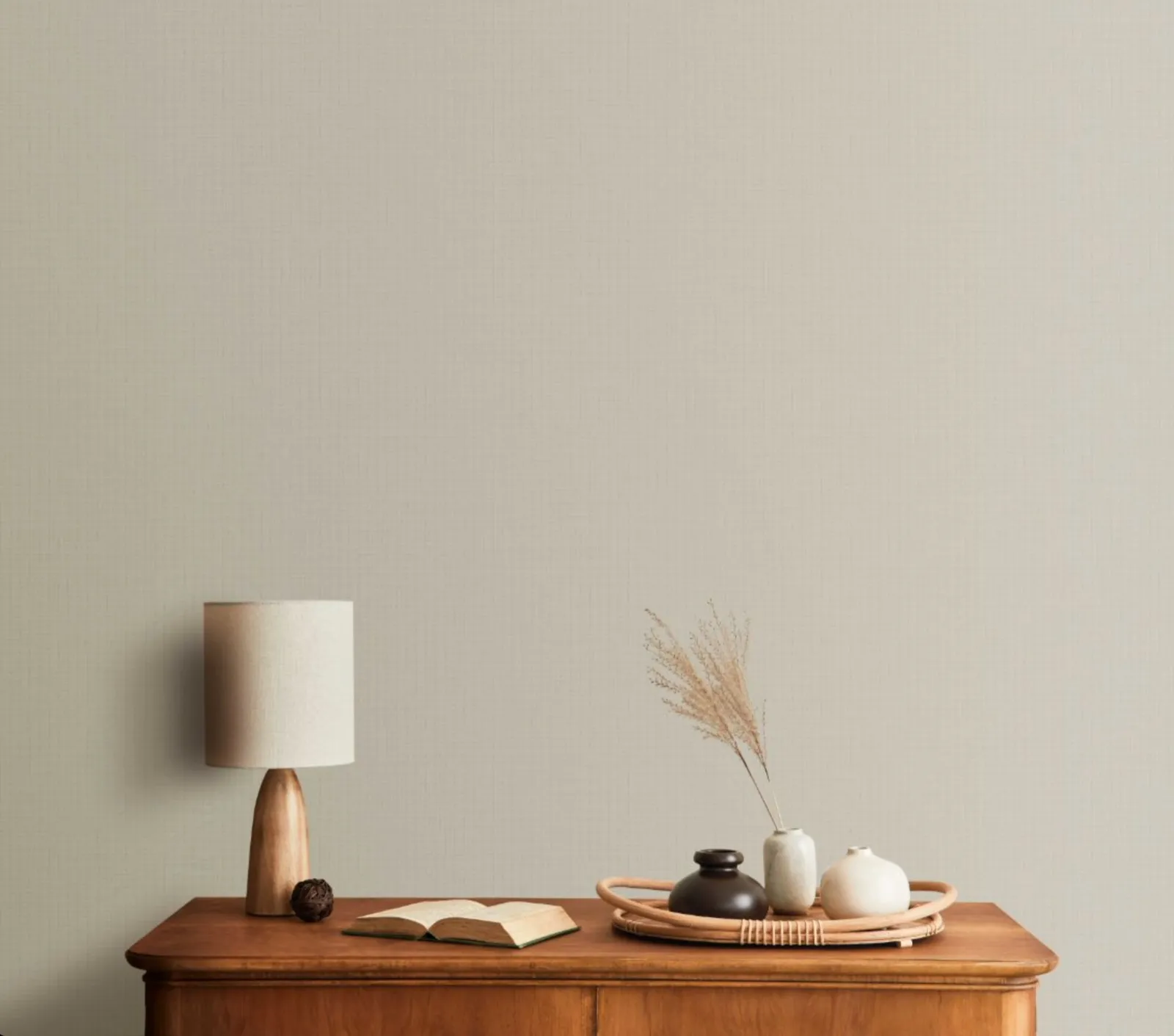 Minimalist space with dark surface against a reddish-pink wall